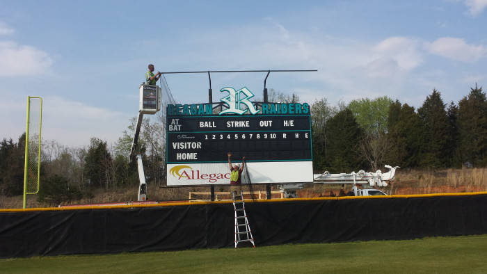 LED Baseball Scoreboard Installed with Protective Net structure and illuminated truss sign